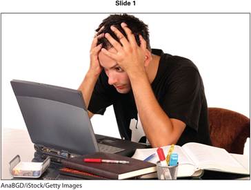 A photo on the slide shows a young man looking at the screen of a laptop. He is supporting his head with both his hands, while his elbows are resting on the table.
