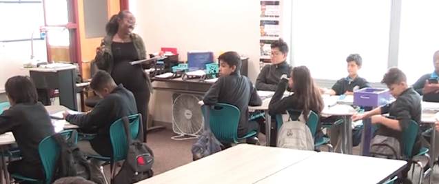Photo depicts BreOnna's bright smile and relaxed posture as she asks Adriel's classmates to “snap it up” for him ensures her actions will be received as they are intended.