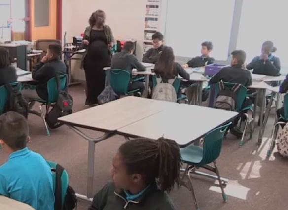 Photo depicts a still shot of BreOnna having turned to face the class fully to show that they, and the coming task, are her singular priority.